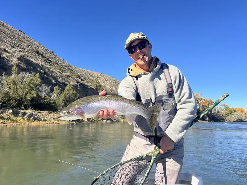 Brett Seng with a big rainbow trout on a bluebird day