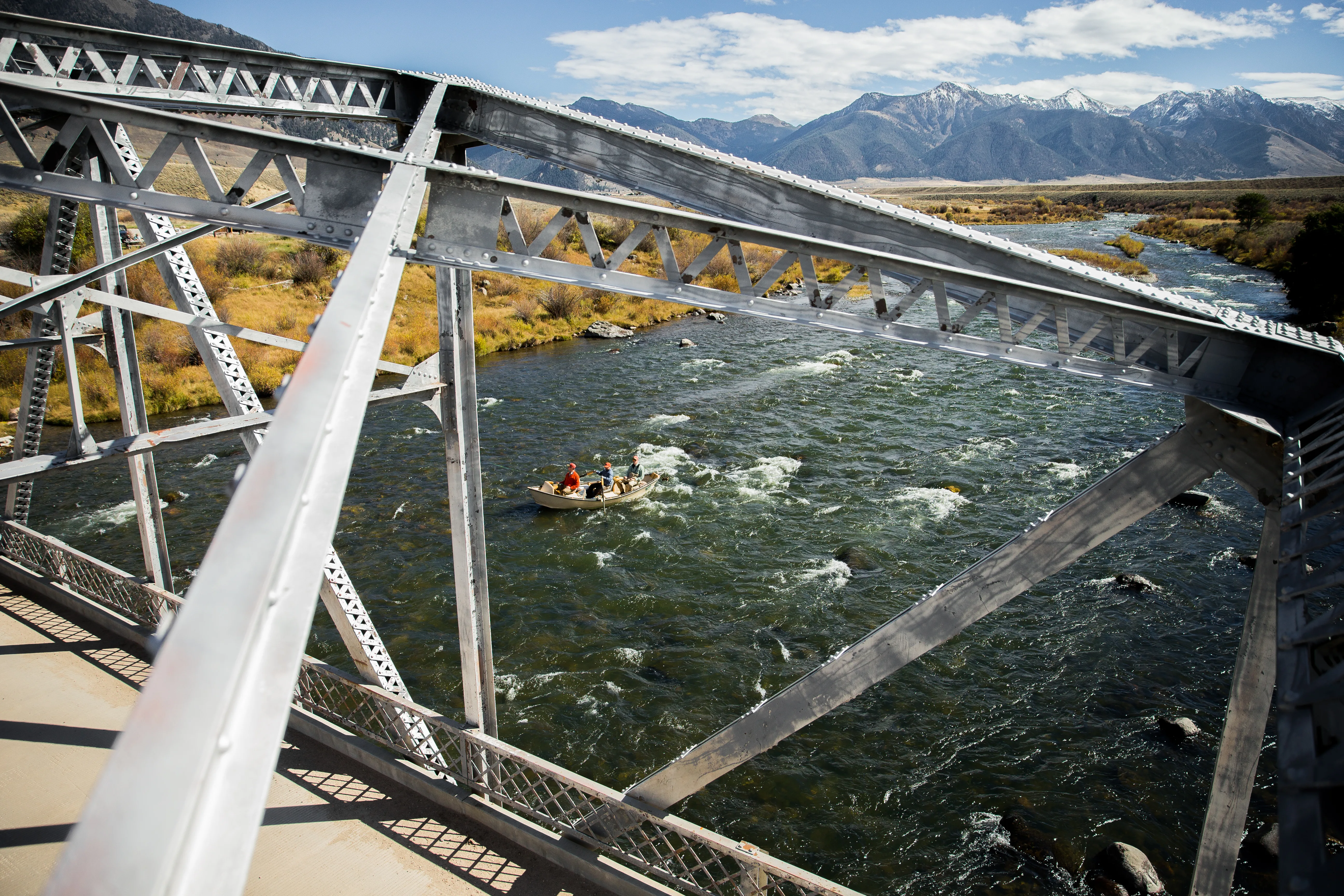 Floating through a steel bridge with snowy mountains